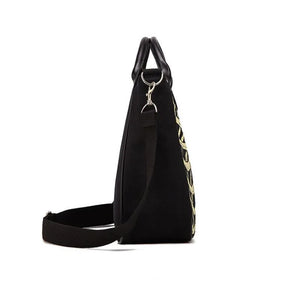 Black tote bag with a pale skeleton ribcage print and a detachable shoulder strap