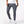 Man in gray skinny cargo jeans with a white tee, front view of the slanted pockets and thigh flap pockets