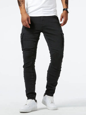 Black skinny cargo jeans worn with a white tee and white sneakers, front view of the slim tapered legs