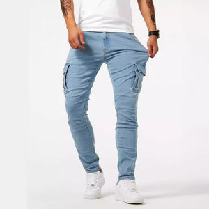Light blue skinny jeans with cargo pockets, front view of a man walking in white sneakers