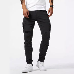 Black skinny denim cargo jeans, front view with one hand in the pocket and flap pockets on both thighs