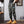 Front view of the army green Slim Camo Cargo Pants, hands in pockets, tapered cuffs over tan boots