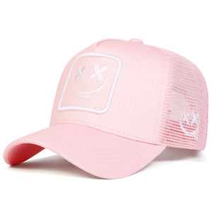 White trucker cap with an XX smiley face patch and mesh back