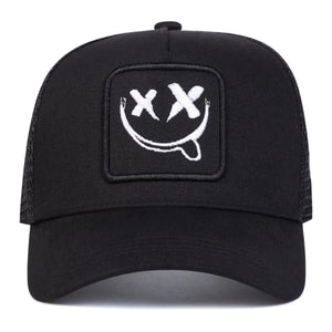 White trucker cap with an XX smiley face patch and mesh back