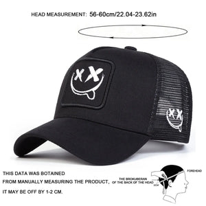 White trucker cap with an XX smiley face patch and mesh back