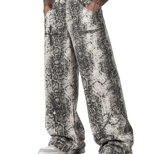 A model wears the snake print trousers, the wide leg breaking over the shoe at the hem