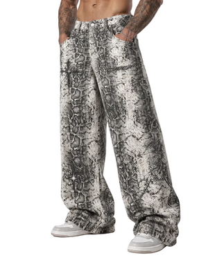 A model wears the snake print trousers, the wide leg breaking over the shoe at the hem