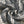 The snake print twisted close up, cream scales breaking over a charcoal ground