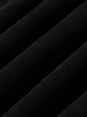 Folds of the heavy cotton laid across each other, showing the depth of the washed black