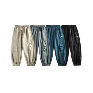Four pants side by side in khaki, sage, teal blue and black, front view with curved knee seams