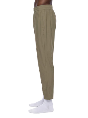 Side view of the Khaki athletic pants on a model, showing the straight leg and the ankle length hem