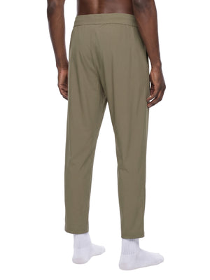 Khaki straight leg pants in a back three-quarter view on a model, showing the relaxed seat and straight leg