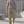 Khaki straight leg athletic pants worn with a gray tank top and white sneakers, front walking view outdoors