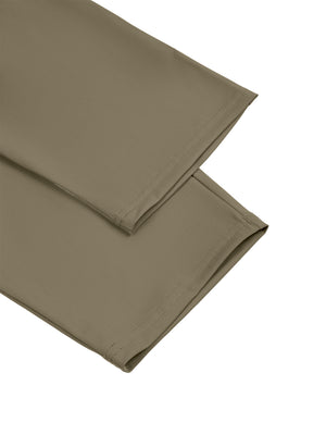 Detail of the open straight hem on the Khaki athletic pants, two legs folded on a white background