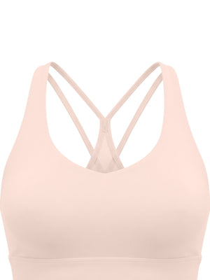 Close-up of the light pink front, the scoop neckline cut smooth with no seam across the cups