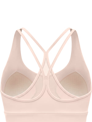 Back of the light pink bra up close, the double straps meeting at the centre over the mesh panel
