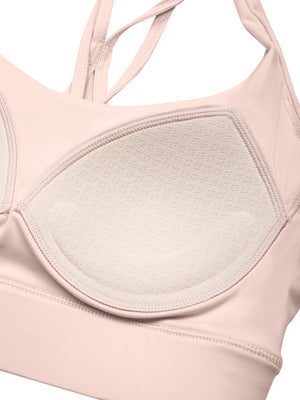 Close-up of a padded cup inside the light pink sports bra, the pad sitting in the cup lining