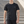 Black slim fit training t-shirt worn front walking view on steps, small white chest wordmark