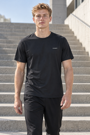 Black slim fit training t-shirt worn front walking view on steps, small white chest wordmark