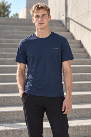 Navy Blue slim fit training t-shirt on a man outdoors, front view with a hand in the pocket