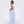 Back three-quarter view of the sky blue striped wide leg trousers, showing the hip pocket and full leg