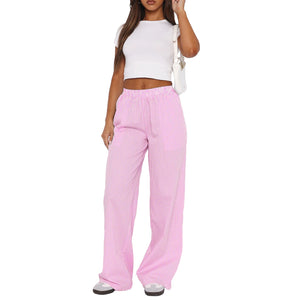 Pink pinstripe wide leg pants with an elastic high waist, full front view with a white baby tee