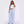 Front view of the pale blue Striped Wide Leg Y2K Pants, worn with a white tee and white trainers