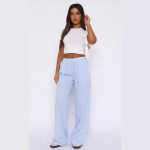 Front view of the pale blue Striped Wide Leg Y2K Pants, worn with a white tee and white trainers