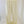 Pale butter yellow wide leg pants with an elastic waistband, front view on a wooden floor