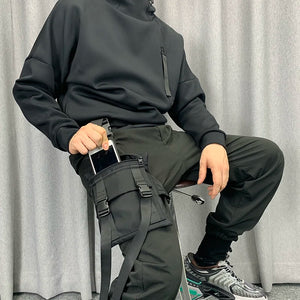 Black tactical techwear leg bag strapped to the thigh