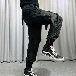 Black tactical techwear leg bag strapped to the thigh