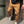 Khaki Tapered Cargo Jogger Pants on a model against a brick wall, flap pocket and gathered ankle cuff