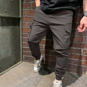 Gray Tapered Cargo Jogger Pants worn with white sneakers, cargo pocket on the leg and elastic cuff
