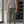 Man in Gray Green Tapered Drawstring Gym Sweatpants and a gray tank top, front view inside a gym