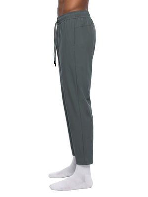 Side view of the Dark Gray tapered pants on a model, long drawstring and slim ankle length leg