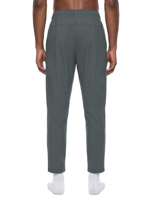 Back view of the Dark Gray workout pants on a model, smooth seat and tapered legs above white socks