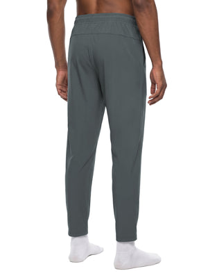 Dark Gray workout pants in a back three-quarter view on a model, showing the tapered leg line