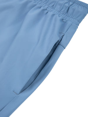 Detail of the side pocket on the Blue tapered workout pants, set into the seam under the waistband