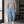 Blue tapered workout pants worn front view in a gym, white drawstring and cropped ankle length