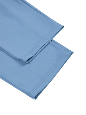 Detail of the straight hem on the Blue tapered pants, two folded legs on a white background