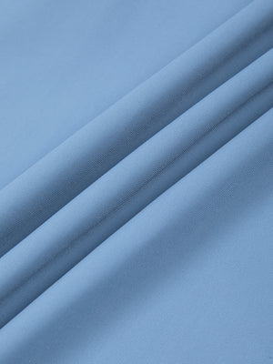 Close-up of the Blue nylon and spandex fabric of the tapered workout pants, smooth matte surface