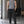 Black tapered drawstring workout pants on a man in a gym, front view with hands in the side pockets
