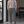 Dark Gray tapered workout pants worn front view in a gym, drawstring waist and small logo on the thigh