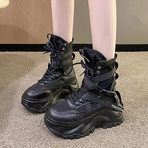 Tech Wear Boots Black worn by a model, front view of the chunky lug sole, laces and wrapped ankle straps