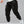 Techwear flap cargo pants in black, front view on model with drawstring waist