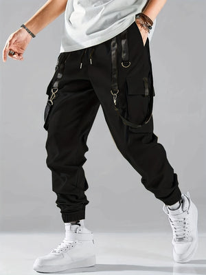 Techwear flap cargo pants in black, front view on model with drawstring waist