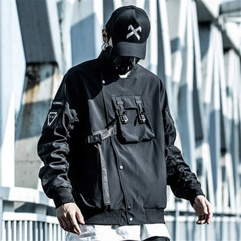 Person wearing a black jacket and cap with a geometric design, standing against a modern architectural background.