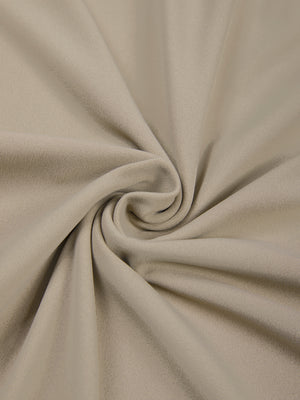 Khaki bodysuit fabric twisted into a spiral, close-up of the thin and smooth nylon and spandex knit