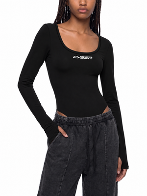 Black long sleeve bodysuit on a model, front view with a hand in the pocket of washed black pants
