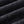 Folds of the snow-washed black cotton jersey of the Tiger Tank Top Y2K, showing its faded tone
